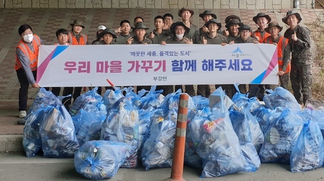 ▲ 육군 군수사령부 예하 종합보급창 장병들이 4일 세종시 부강면 갈산교차로 주변에서 환경정화 활동에 동참해 폐기물 등을 수거한 뒤 기념촬영을 하고 있다.ⓒ부강면사무소