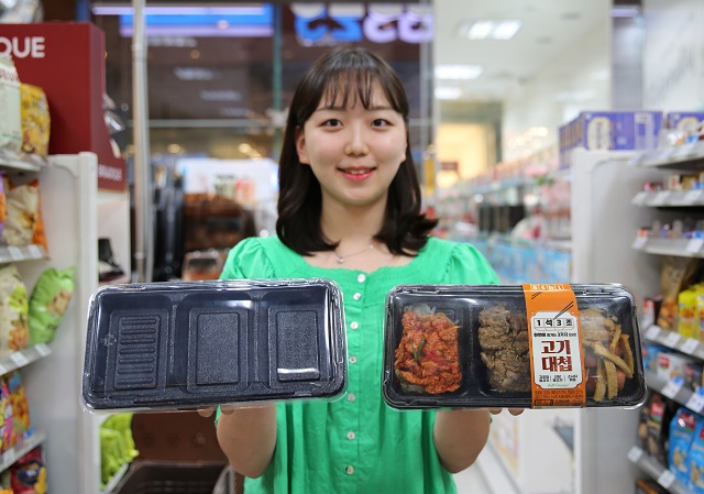▲ 모델이 탄소 배출량 25%를 절감한 발포용기와 해당 용기를 사용한 간편식을 들고 포즈를 취하고 있다.ⓒGS리테일