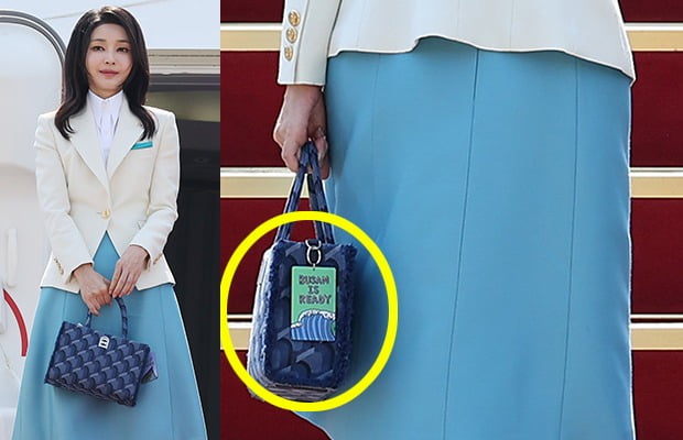 ▲ 윤석열 대통령과 함께 프랑스·베트남을 방문하는 김건희 여사가 19일 성남 서울공항에서 출국하며 손가방에 