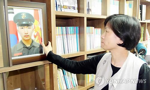 ▲ 북한의 연평도 도발 당시 북한의 포격으로 숨진 고 서정우 하사의 어머니 김오복 씨가 연평도 포격전 1주년을 앞둔 2011년 11월 11일 광주 남구 자택에서 아들의 사진을 보고 있다. ⓒ연합뉴스