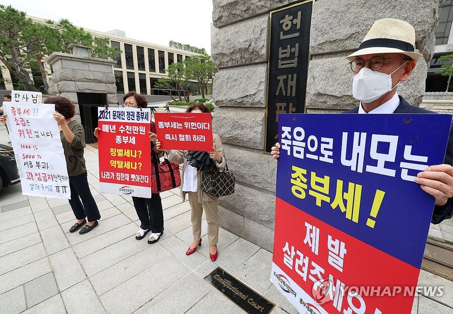 ▲ 30일 오후 서울 종로구 헌법재판소 앞에서 시민들이 종부세 규탄 피켓을 들고 서 있다.ⓒ연합뉴스