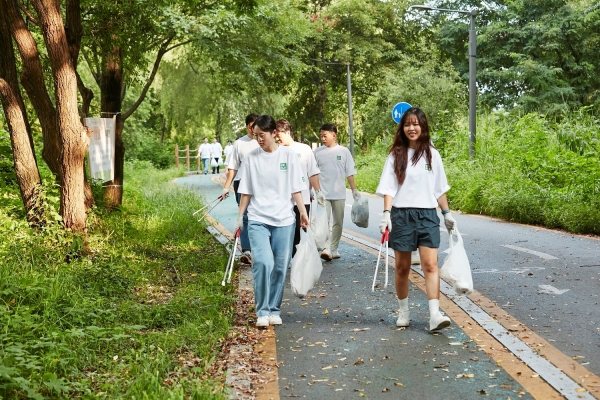 ▲ 지역 사회에 감사의 마음을 전하기 위해 송파둘레길탄천길 곳곳을 살피며 쓰레기를 수거하고 있는 유니클로 임직원들ⓒ유니클로
