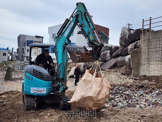 ▲ 영일만지부 회원들이 굴착기를 이용해 해양쓰레기를 깨끗하게 수거하고 있다.ⓒ뉴데일리