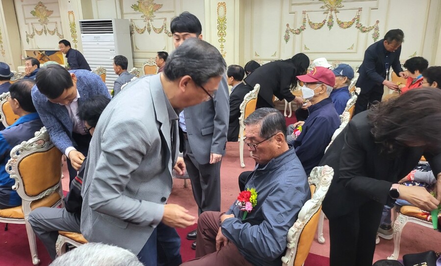 ▲ 유호광(앞줄 가운데) 조합장과 서청주농협 임직원들이 어버이날 기념행사에서 원로 조합원들에게 카네이션을 달아드리고 있다.ⓒ서청주농협