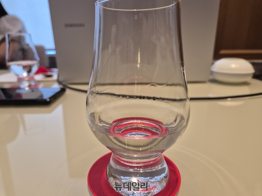 ▲ 잔에 따른 화요19金. 투명하면서도 옅은 황금빛이 특징이다.ⓒ조현우 기자