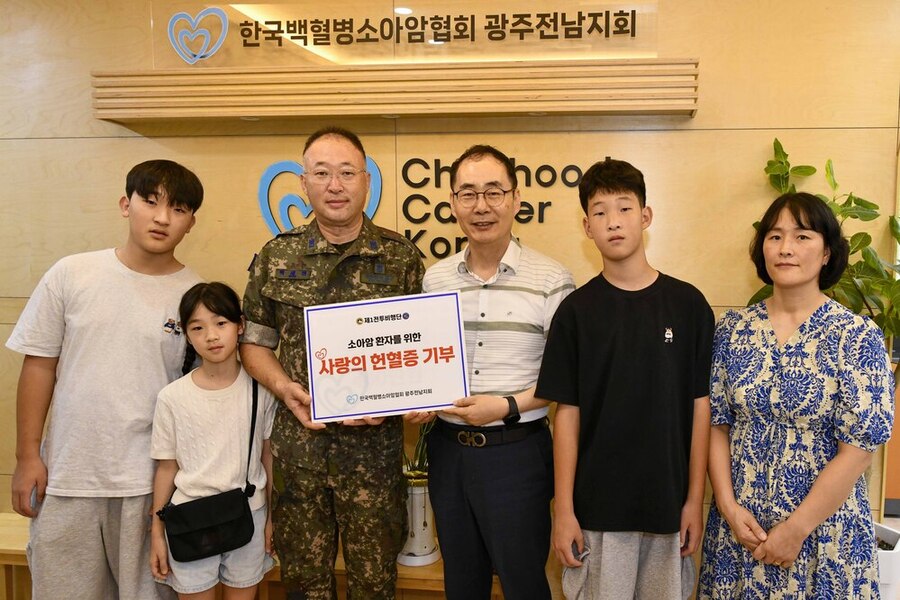 ▲ 백세현 원사가 헌혈증을 전달하며 협회 관계자 및 가족들과 기념 촬영을 하고 있다.ⓒ공군 제1전투비행단 제공