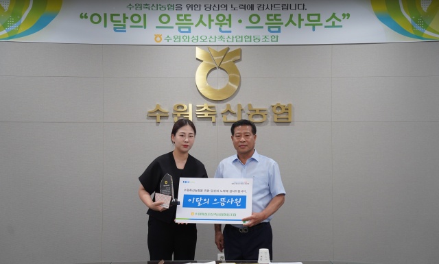 ▲ 장주익 수원축협 조합장(오른쪽)이 발안지점 이유경 계장에게 이달의 으뜸사원 상패를 전달한 뒤 기념촬영을 하고 있다. ⓒ수원축협 제공