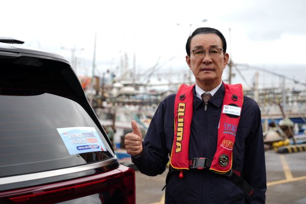 ▲ 노동진 수협중앙회장이 26일 제주항에서 '도로에는 안전벨트, 바다에는 구명조끼'라는 슬로건이 적힌 홍보스티커가 부착된 차량과 함께 챌린지에 참여하고 있다. ⓒ수협중앙회