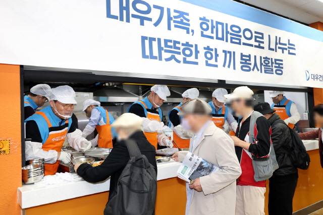 ▲ 김보현(왼쪽) 대우건설 대표이사와 심상철(오른쪽) 노동조합 위원장이 무료 급식 봉사활동에 참여하고 있다.ⓒ대우건설