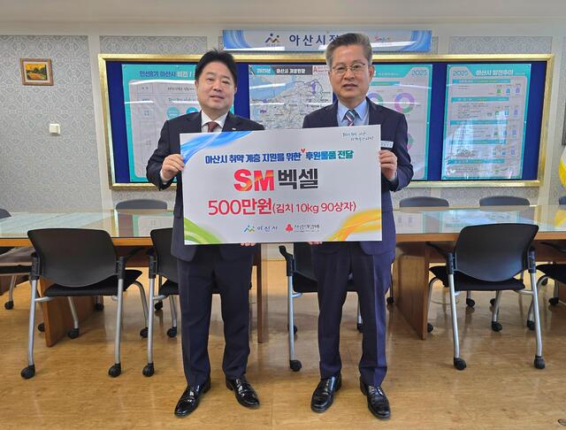 ▲ SM벡셀 자동차사업부문 유병선 대표이사(왼쪽)가 지난 23일 충남 아산시청에서 열린 2025년 ‘사랑의 김치 나눔’ 지원사업 후원금 전달식에 참석해 아산시 김범수 부시장과 기념촬영을 하고 있다. ⓒSM그룹