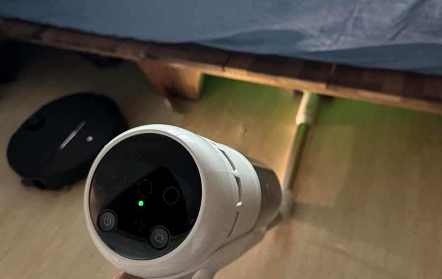 ▲ 침대 밑 청소를 하는 모습. 옆에 로봇청소기도 보인다. ⓒ김재홍 기자