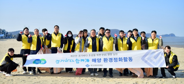 ▲ 시석중 경기신보 이사장을 비롯한 임직원들이 안산시 대부도 방아머리 해수욕장 일대에서 해양 정화 활동을 마친 뒤 기념촬영을 하고 있다. ⓒ경기신보 제공