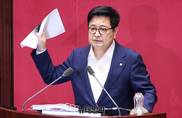 ▲ 김장겸 국민의힘 의원이 5일 오후 국회에서 열린 본회의에서 방송문화진흥회법 일부개정법률안이 상정되자 무제한 토론(필리버스터)을 하며 보좌진 명의의 차명 계좌로 주식 거래를 했다는 의혹을 받고 있는 이춘석 더불어민주당 의원 관련 기사를 들어보이고 있다. 2025.08.05. ⓒ서성진 기자