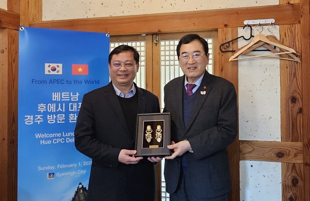 ▲ 주낙영 시장(오른쪽)이 지역의 한 음식점에서 응우옌 타인 빈 베트남 후에중앙직할시 부시장과 기념품을 교환하며 기념촬영을 하고 있다.ⓒ경주시