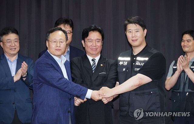 ▲ 20일 경기도 수원시 장안구 경기고용노동청에서 삼성전자 노사가 임금협상 잠정 합의안에 서명한 후 여명구 삼성전자 DS(디바이스솔루션·반도체 사업 담당) 피플팀장, 김영훈 고용노동부 장관, 최승호 삼성그룹 초기업노동조합 삼성전자지부 위원장이 손을 맞잡고 있다.ⓒ연합뉴스