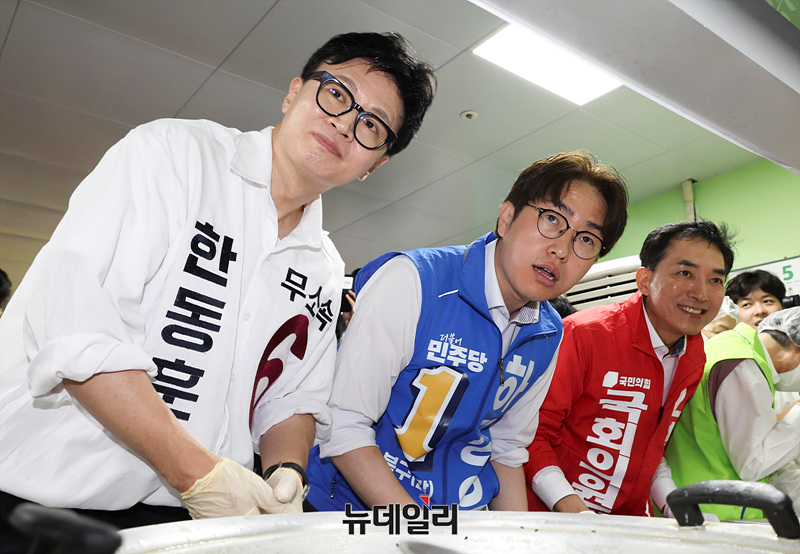 ▲ 한동훈 무소속 부산 북갑 국회의원 후보, 하정우 더불어민주당 후보, 박민식 국민의힘 후보가 지난 21일 부산 북구 남산정종합사회복지관에서 콩국수 나눔 봉사를 하며 지지를 호소하는 모습. ⓒ서성진 기자