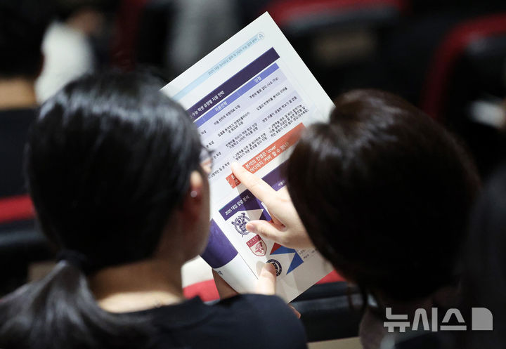 ▲ 2026 대입 진학지도 설명회에서 참석자가 자료를 살펴보고 있다.ⓒ뉴시스