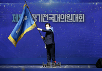 [포토] 당기 흔드는 이재명 민주당 신임 당대표